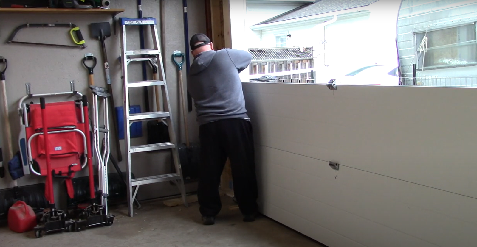 a professional installing garage door