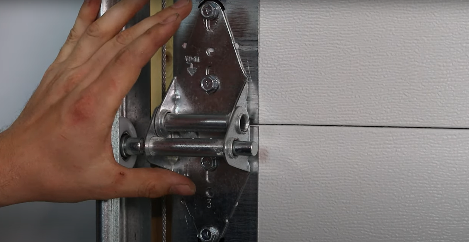 checking the garage door hinges if it is the source of noisy garage door