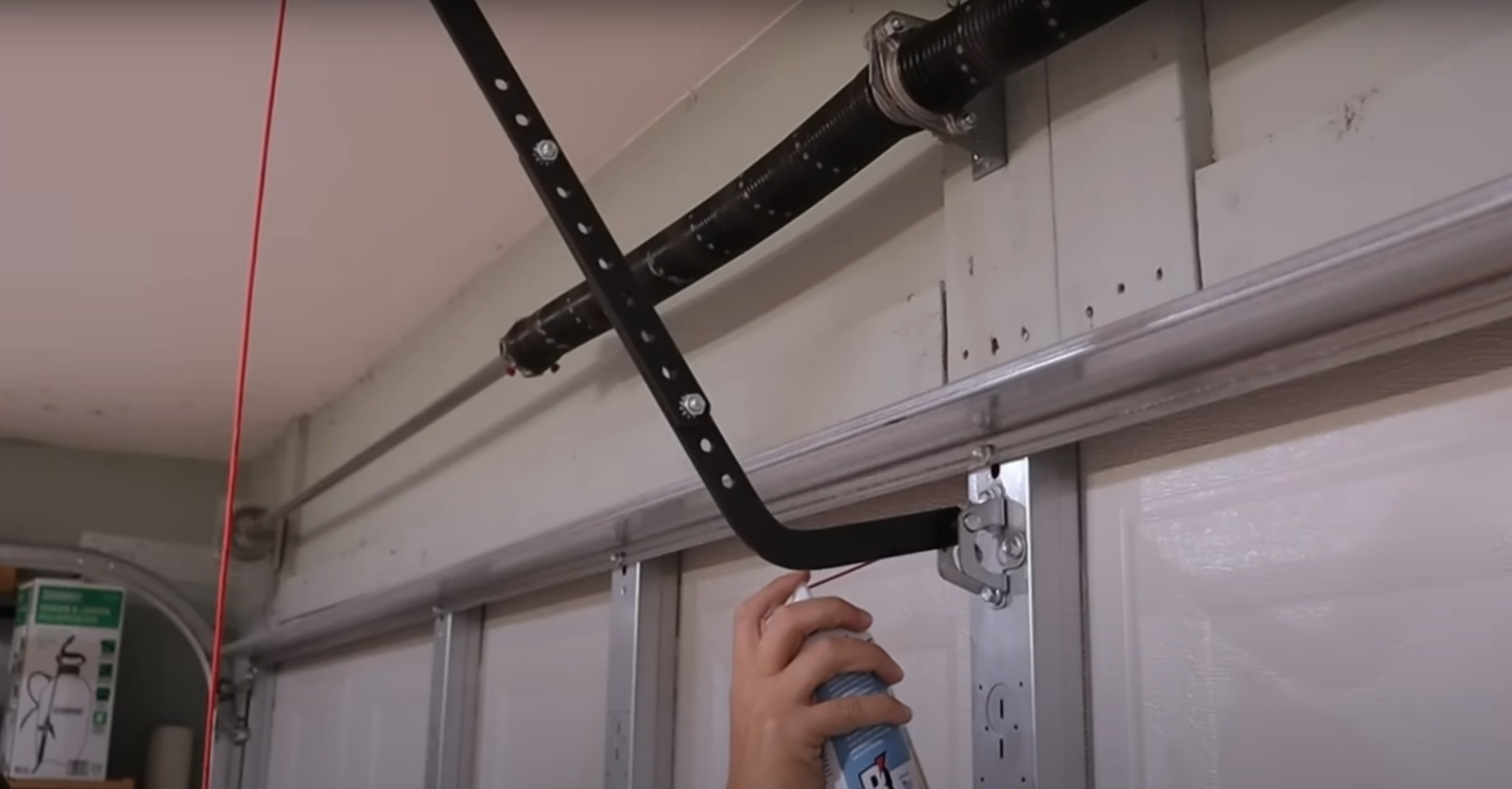 lubricate garage door track to reduce noise