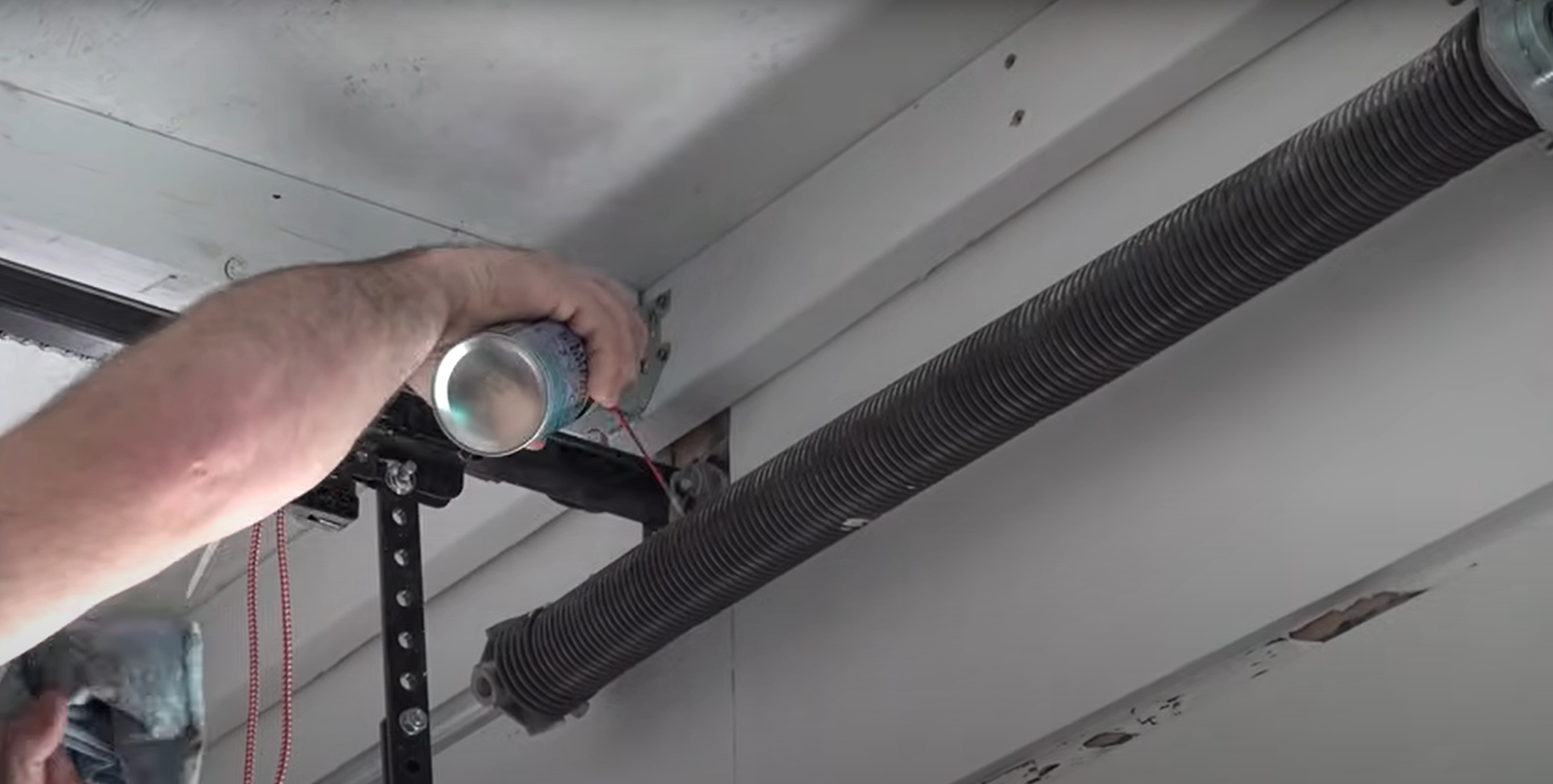 putting some lubricant on garage door spring