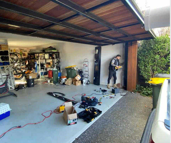 a man replacing a garage door