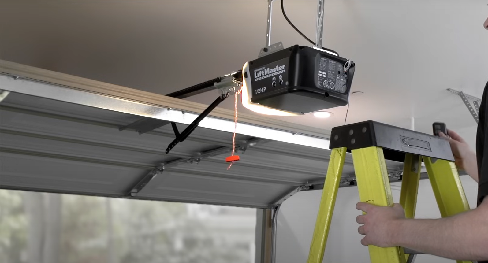 Expert technician fixing a garage door opener in Sarasota, ensuring reliable operation for a local homeowner.