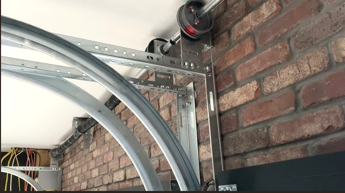 Technician performing garage door track repair